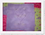 Signature * November 2004 -- Here is my signature square. I embroidered the purple flower first, with my signature. Then I sandwiched the block together and embroidered the heart. * 500 x 375 * (26KB)